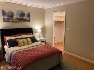 2920 Ramsgate Ct, Winston-Salem, NC 27106 - bedroom with wood finished floors, crown molding, and a spacious closet