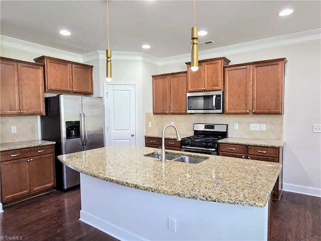 kitchen featuring pendant lighting, sink, dark hardwood / wood-style floors, an island with sink, and stainless steel appliances