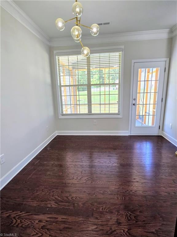 interior space featuring dark hardwood / wood-style floors, ornamental molding, and a chandelier