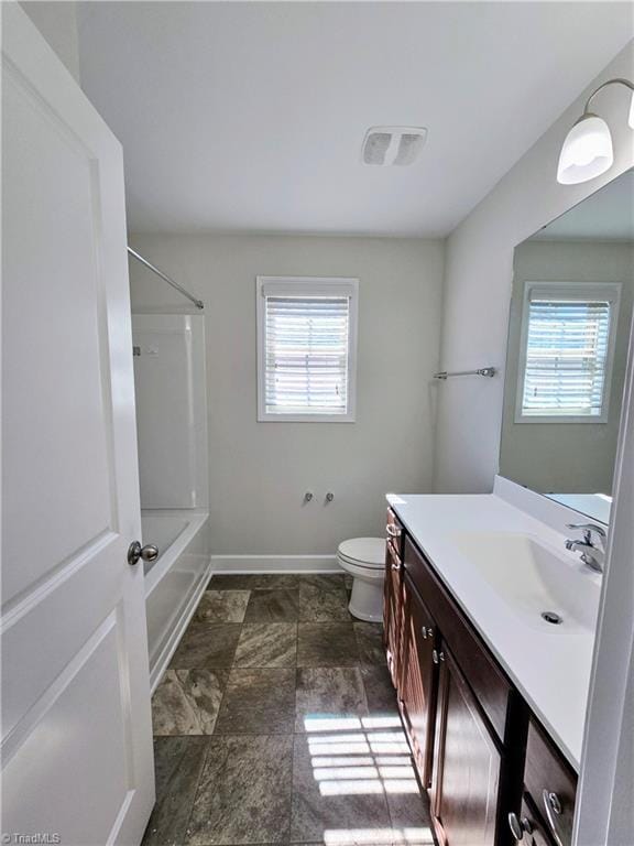 full bathroom featuring a wealth of natural light, vanity, shower / bathtub combination, and toilet