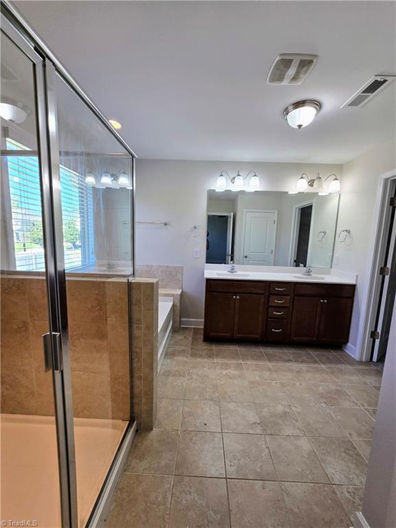 bathroom with separate shower and tub, tile patterned flooring, and vanity