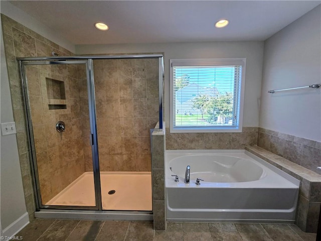 bathroom featuring independent shower and bath