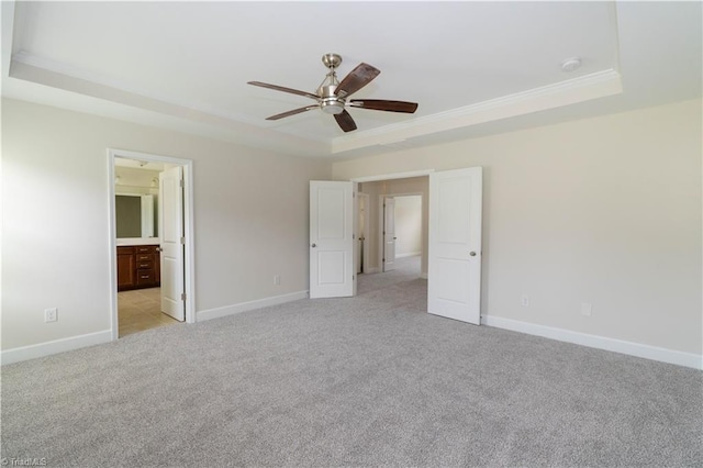 unfurnished bedroom with light carpet, a raised ceiling, and ceiling fan