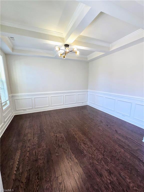 spare room with coffered ceiling, an inviting chandelier, crown molding, dark hardwood / wood-style floors, and beam ceiling