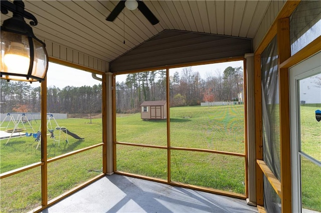 unfurnished sunroom featuring ceiling fan, wood ceiling, and vaulted ceiling