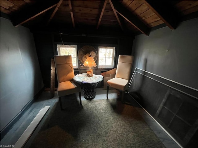 living area with lofted ceiling with beams and wood ceiling