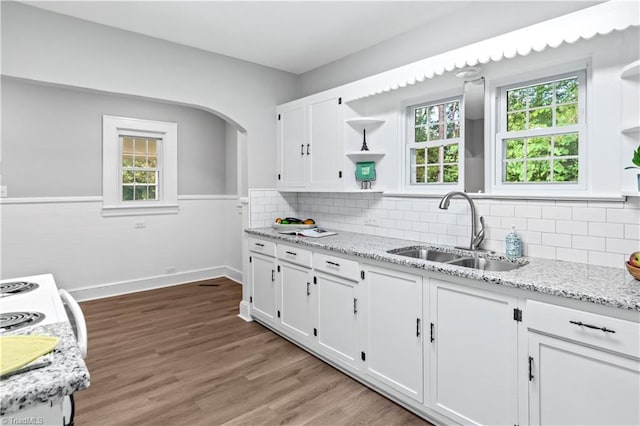 7090 Reynolda Rd, Pfafftown, NC 27040 - kitchen with open shelves, white cabinetry, light stone counters, and light wood-style floors