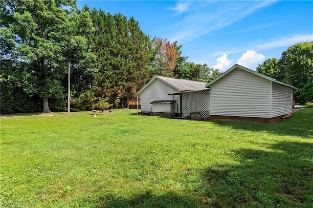 7090 Reynolda Rd, Pfafftown, NC 27040 - view of side of home with a yard and view of wooded area