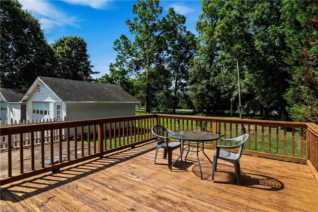 7090 Reynolda Rd, Pfafftown, NC 27040 - deck with outdoor dining space, an outbuilding, and view of scattered trees