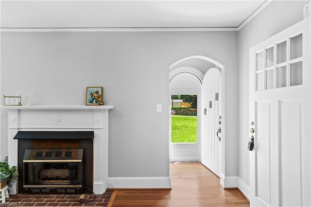 7090 Reynolda Rd, Pfafftown, NC 27040 - entryway featuring a fireplace with flush hearth, wood finished floors, and crown molding