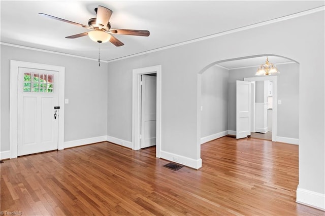 7090 Reynolda Rd, Pfafftown, NC 27040 - empty room featuring arched walkways, light wood-type flooring, ceiling fan, and ornamental molding