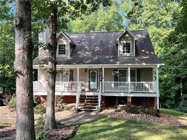 cape cod home featuring a porch