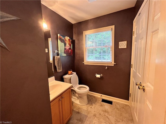 bathroom featuring vanity and toilet