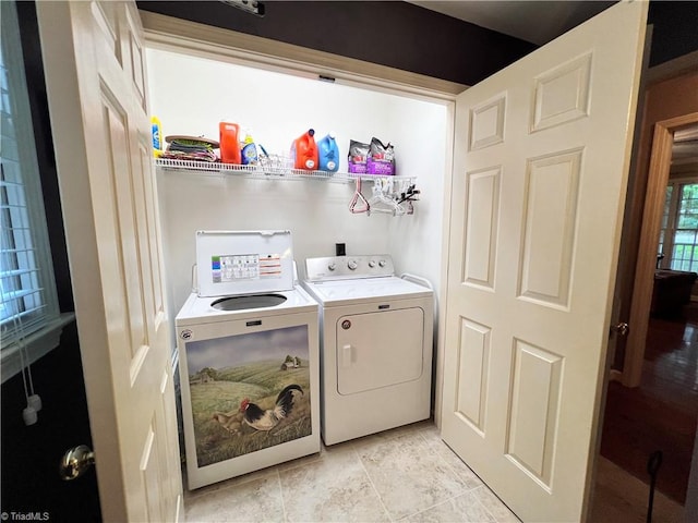 laundry area with light tile patterned floors and independent washer and dryer