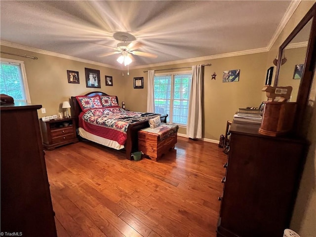 bedroom with hardwood / wood-style floors, ceiling fan, and ornamental molding