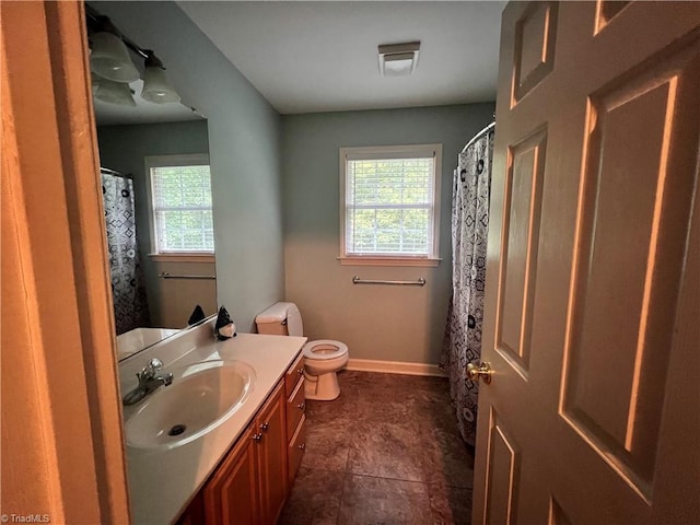 bathroom featuring tile patterned flooring, vanity, and toilet