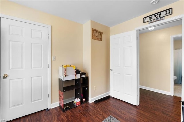 interior space with baseboards and dark wood finished floors