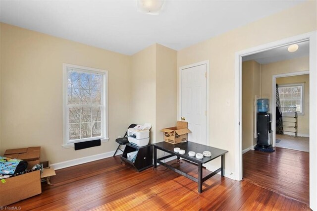 misc room with wood-type flooring and baseboards