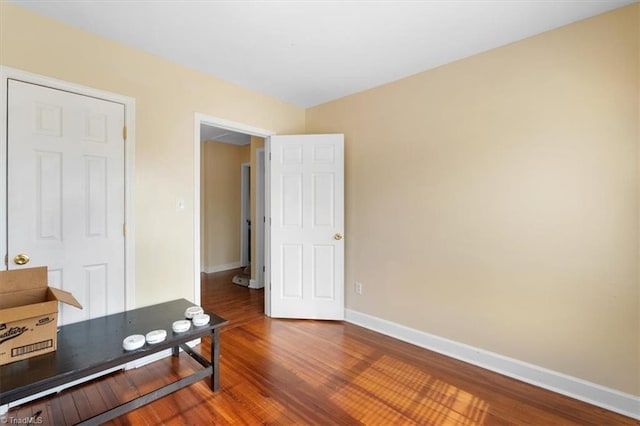 office space featuring baseboards and wood finished floors