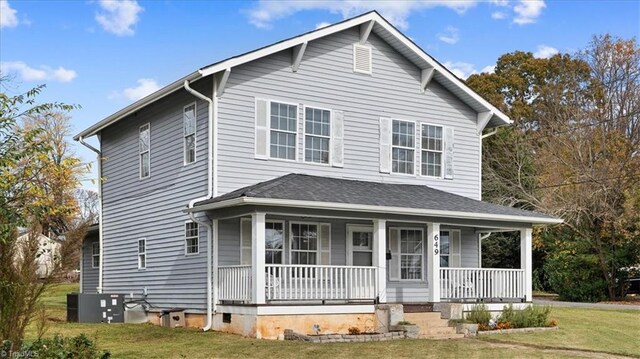 view of front of house featuring a porch, a front lawn, and central AC unit