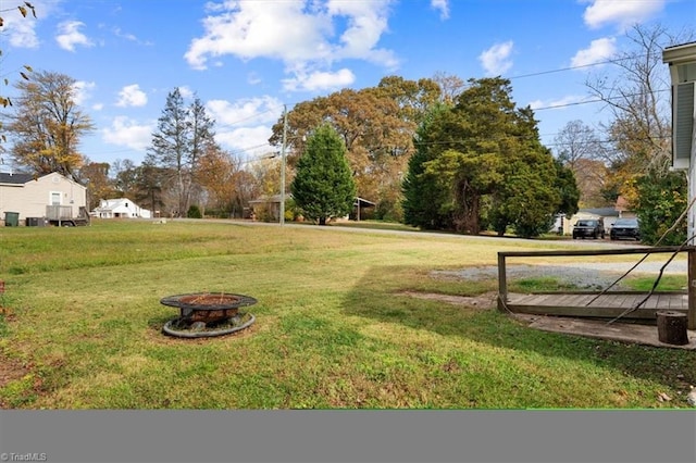 view of yard with an outdoor fire pit