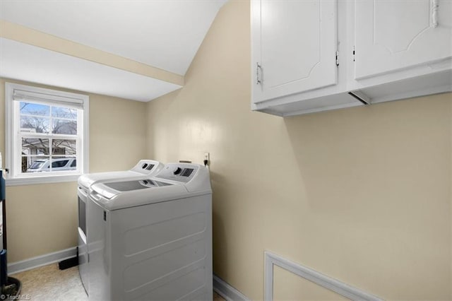 laundry area with cabinet space, baseboards, and separate washer and dryer