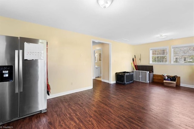 interior space with baseboards and wood finished floors