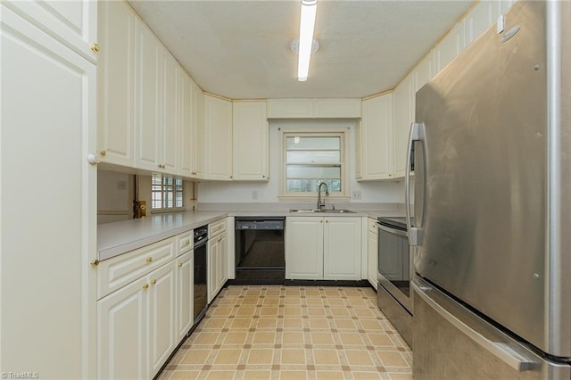 kitchen with sink, white cabinets, and appliances with stainless steel finishes