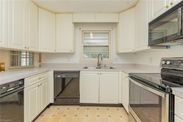 kitchen with sink, white cabinetry, and black appliances