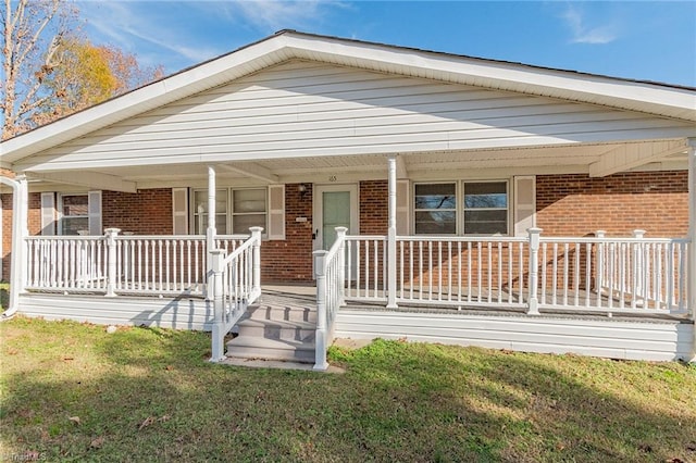 view of front of property with covered porch and a front yard