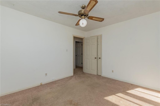 spare room with light carpet, a textured ceiling, and ceiling fan