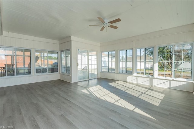 unfurnished sunroom with plenty of natural light and ceiling fan