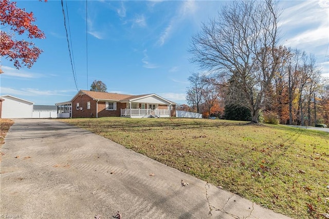 ranch-style house with covered porch and a front lawn