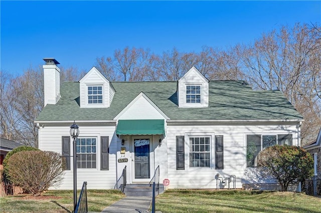 cape cod house with a front yard