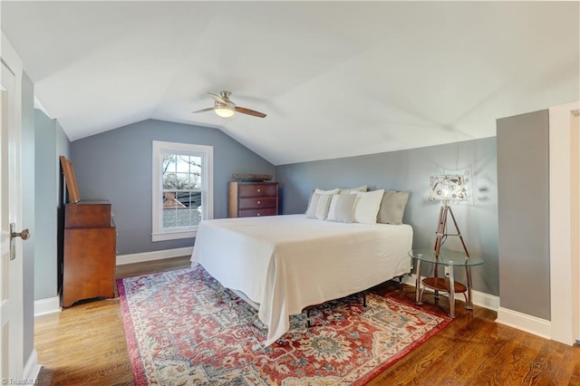 bedroom featuring ceiling fan, hardwood / wood-style floors, and vaulted ceiling