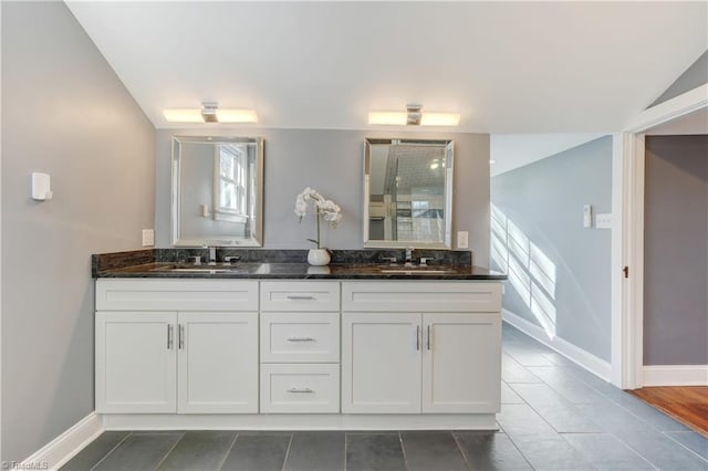 bathroom with tile patterned floors, vanity, vaulted ceiling, and an enclosed shower