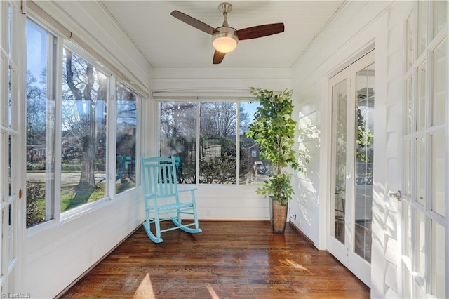 unfurnished sunroom featuring ceiling fan and french doors