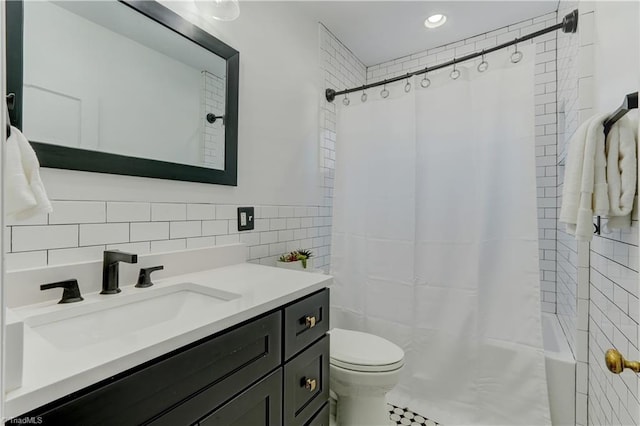 bathroom featuring curtained shower, vanity, tile walls, and toilet