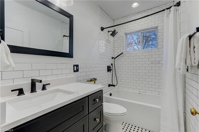 full bathroom with shower / bath combination with curtain, vanity, toilet, and tile walls