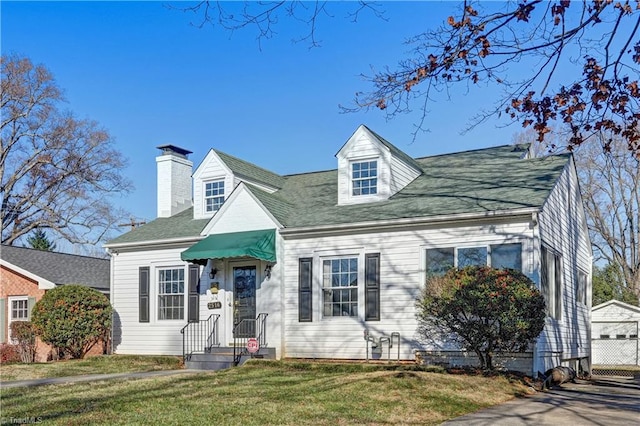 new england style home featuring a front yard