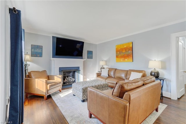 living room with hardwood / wood-style floors and ornamental molding