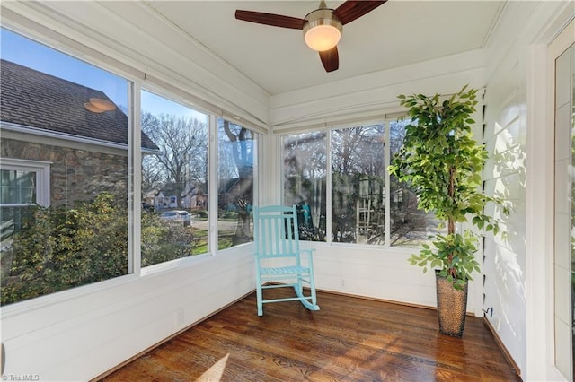 sunroom featuring ceiling fan