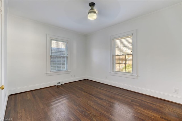 spare room with dark hardwood / wood-style floors and a healthy amount of sunlight