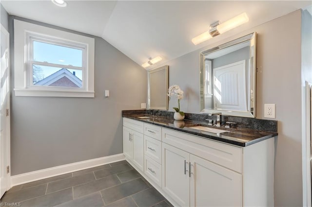 bathroom with tile patterned floors, vanity, and lofted ceiling