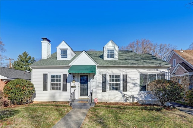 new england style home with a front lawn