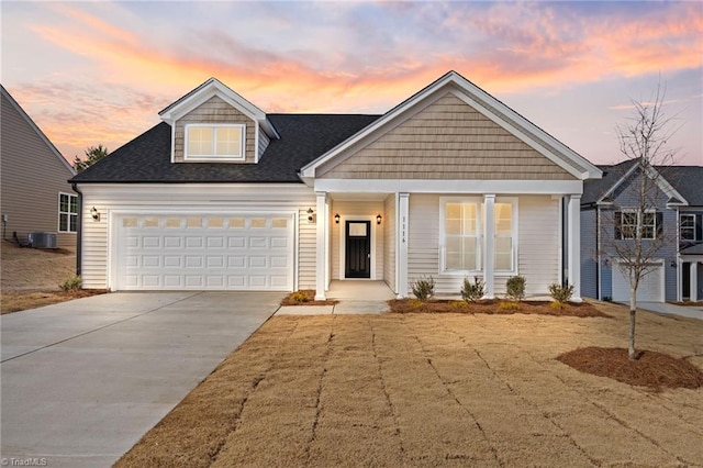 view of front of house featuring a garage and central air condition unit