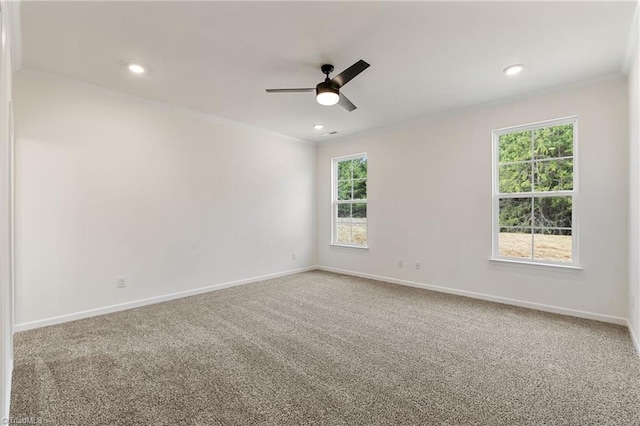 carpeted spare room with ornamental molding and ceiling fan