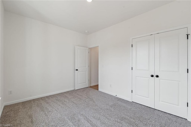 unfurnished bedroom with carpet floors and a closet