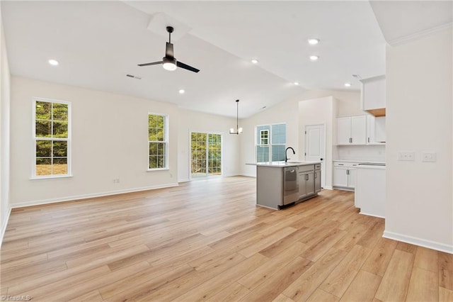 unfurnished living room with ceiling fan with notable chandelier, vaulted ceiling, sink, and light wood-type flooring