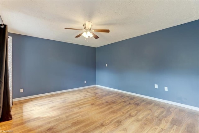 unfurnished room featuring light hardwood / wood-style flooring, ceiling fan, and a textured ceiling